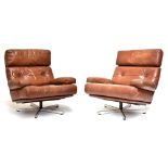 A pair of 1970s brown leather swivel chairs raised on chrome bases, height 84cm. Additional