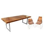 A Scandinavian rosewood dining suite comprising refectory table, raised on chrome block supports,