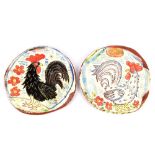 BEN FOSKER (born 1960); a near pair of slip decorated earthenware dishes depicting cockerels,