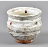 ROBIN WELCH (born 1936); a stoneware yunomi covered in white glaze with red enamel, impressed RW