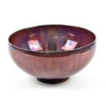 SUTTON TAYLOR (born 1943); an earthenware footed bowl covered in lustrous decoration, impressed ST