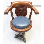 A Victorian mahogany captain's chair on cast iron base,