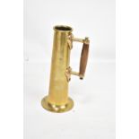 A late 19th century brass steam ship salinometer test jug with wooden handle and copper rivets,