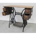 A Singer sewing machine cast iron treadle base with four drawers, width 87.