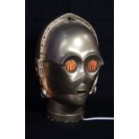 STAR WARS; a model C-3PO head now used as a lamp, offered with a small associated spotlight,