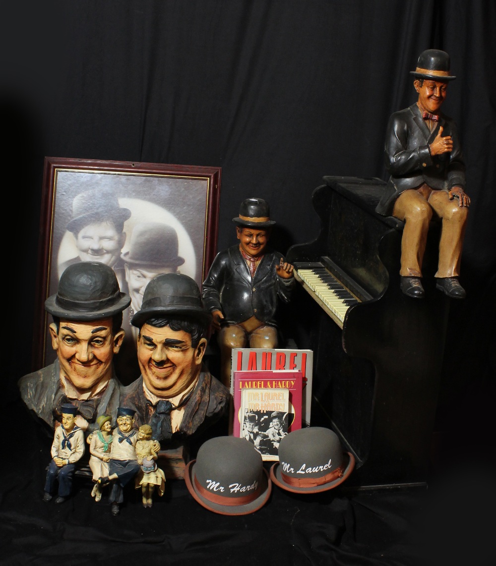 LAUREL AND HARDY; a group of reproduction figures and busts including Hardy sitting at piano, height