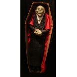 VAMPIRE INTEREST; a model of Dracula in coffin, length 180cm, and large related framed picture.