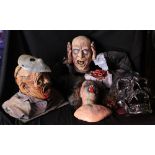 A group of horror busts and figures to include a bust with hockey mask, a plaster plaque of Regan