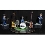 THE BEATLES; a novelty miniature display featuring stylised figures of Paul McCartney, John