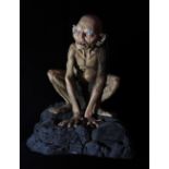 THE LORD OF THE RINGS; a figure of Gollum on modelled rocky base, height 66cm.