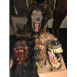 A rubber werewolf head, height approx 36cm, and two further similar with one mounted on wooden board