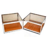 HOWARD MILLER FOR MDA; a pair of retro teak and chrome coffee tables, each of square form, raised on