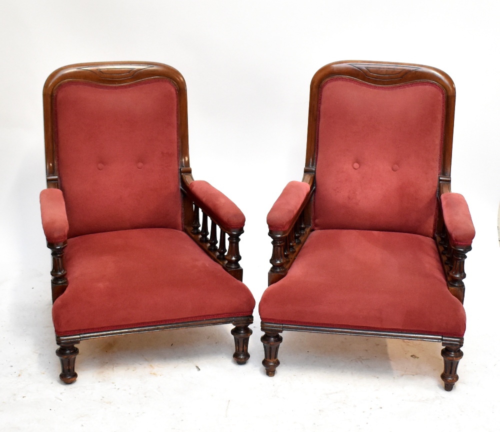 A pair of Victorian mahogany framed library chairs, each raised on column supports (2).