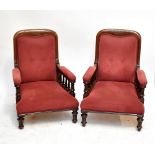 A pair of Victorian mahogany framed library chairs, each raised on column supports (2).