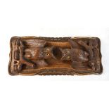 A Black Forest book slide, the ends carved as owls with inset glass eyes on shaped base, width