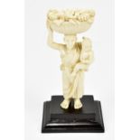 A late 19th/early 20th century carved ivory figure modelled as woman with child holding basket of