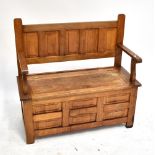 An oak hall bench with hinged seat, width 105cm.