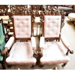A good pair of Victorian oak armchairs, the backs with well carved detail of bird amongst leaves,