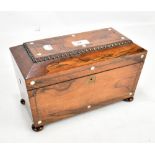 A 19th century rosewood sarcophagus tea caddy, the hinged cover enclosing compartment for a mixing