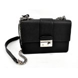 PRADA; a 'Pattino Saffiano' Lux black leather shoulder bag, with silver tone hardware, chain