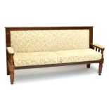 A late 19th/early 20th century walnut framed sofa of typical form, later upholstered in a floral