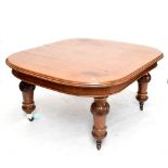 A Victorian oak wind-out extending dining table, with three extra leaves, raised on substantial