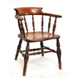A 19th century ash and elm seated smoker's bow back elbow chair.