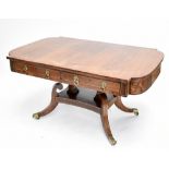 A Regency rosewood and brass inlaid table with two drawers and two dummy drawers, on twin supports