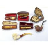 A small group of pipes and cheroot holders including clay and meerschaum examples, predominantly