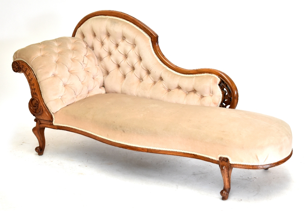 A Victorian carved walnut serpentine fronted chaise longue raised on carved cabriole supports,