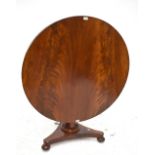 A William IV mahogany breakfast table, the tilt-top above spreading octagonal column raised on