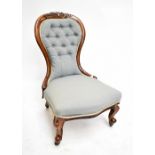 A Victorian mahogany blue upholstered spoon back nursing chair on cabriole legs to castors.