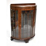An early 20th century mahogany bowfronted glazed display cabinet with three glass shelves, 120 x