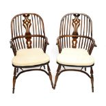 A pair of oak kitchen Windsor spindle back chairs with pierced splats and crinoline stretchers (2).