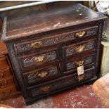 An 18th century carved oak chest of drawers, with single long drawer above four short and a