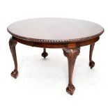 An early 20th century mahogany wind-out extending dining table, raised on carved cabriole supports