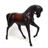 A large early 20th Century Liberty style leather horse, height 110cm (af).