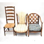 A rush seated ladder back chair, a Victorian nursing chair on castors and a tub chair (3).