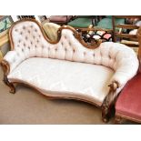 A 19th century walnut scroll back chaise longue with carved foliate detail and pink upholstery,