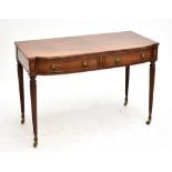 A Regency mahogany bowfronted side table with two short drawers on spiral twist legs to castors,