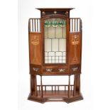 A fine quality Arts & Crafts mahogany display cabinet, the central lead glazed door having three