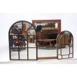 Three decorative mirrors to include a graduated pair of sectional arched mirrors,