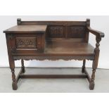 An Old Charm oak linen-fold telephone table with single cupboard supported on turned legs united by