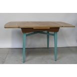 An oak-top draw-leaf table on turquoise blue painted square tapering legs,