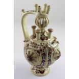 A 19th century J Fischer Budapest puzzle jug with hand painted floral decoration and raised floral