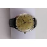 Omega; a tonneau form stainless steel manual wind wristwatch, gilt dial set with baton numerals.