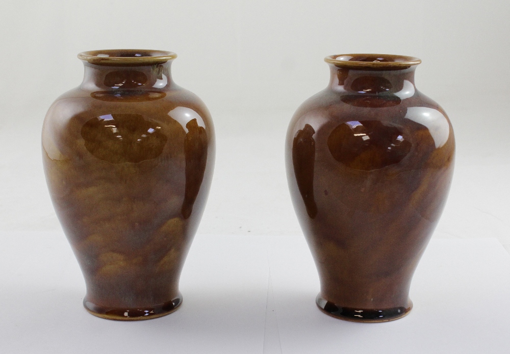 Royal Doulton; a pair of amber ground drip glaze baluster vases,