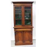 A Victorian chiffonier bookcase, twin glazed doors with three interior shelves,