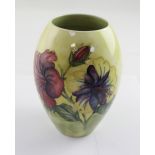 Moorcroft; a yellow drip glaze ground with hibiscus decoration,