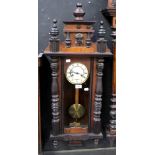 An early 20th century walnut and ebonised beech Vienna style wall clock,